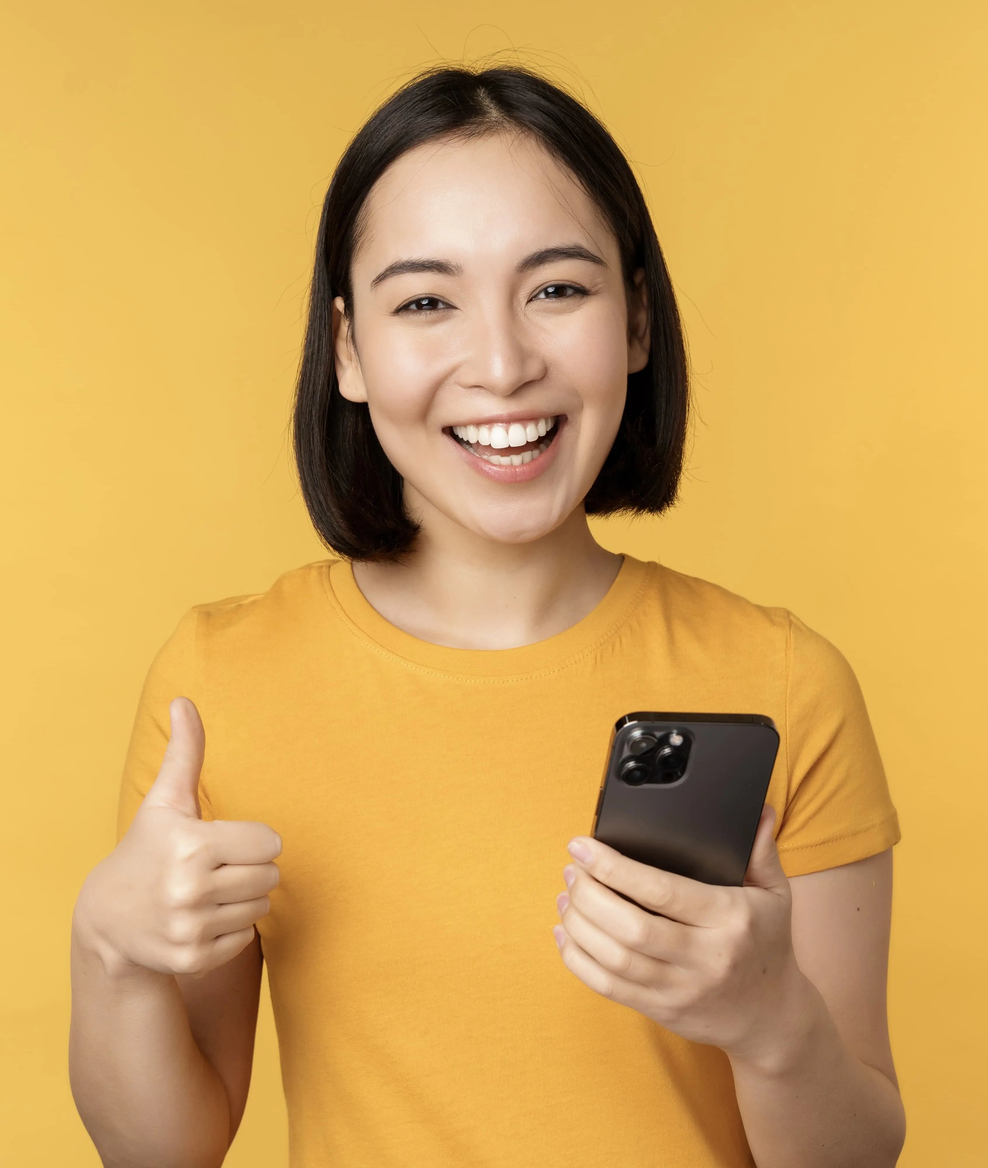 Girl is giving a thumbs up while holding her phone